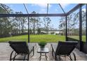 Relaxing screened-in patio with lounge chairs overlooking a beautiful lake view at 17858 Adrift Rd, Winter Garden, FL 34787