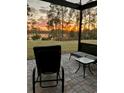 Enjoy the sunset views from this screened patio with pavers and space to entertain at 17858 Adrift Rd, Winter Garden, FL 34787