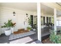 Inviting front porch featuring a stylish door, sleek black shutters and a cozy seating area at 181 N Phelps Ave, Winter Park, FL 32789