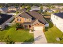 Aerial view of a home showcasing the roof, lawn, landscaping, and a long driveway, capturing a sense of space at 1920 Partin Terrace Rd, Kissimmee, FL 34744