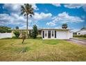 Charming single-story home with a well-maintained lawn and tropical landscaping at 198 Benjamin Dr, Ormond Beach, FL 32176