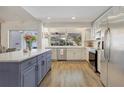 Bright kitchen with a marble countertop island, stainless steel appliances, and garden window at 203 E Sweetwater Creek Dr, Longwood, FL 32779