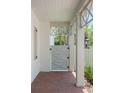 Charming enclosed gate and brick path with overhead trellis and white columns at 3011 Amherst Ave, Orlando, FL 32804