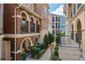 Attractive townhome exterior featuring stucco facade, arched walkways, and a garden at 3321 Messina Dr, Lake Mary, FL 32746