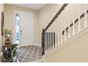 Bright foyer with staircase, light-colored walls, and a stylish area rug at 3321 Messina Dr, Lake Mary, FL 32746