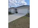 Well-kept one story home with a two car garage, complemented by a green lawn at 3342 Pink Oleander, Mascotte, FL 34753