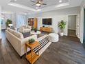 Bright living room boasts wood floors, modern furniture, and a cozy atmosphere, perfect for relaxing or entertaining guests at 3447 Astoria Ct, Winter Park, FL 32792