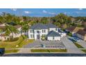 Stunning two-story home boasts manicured landscaping, a beautiful fountain, and a circular driveway at 352 Radisson Pl, Oviedo, FL 32765