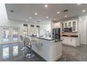 Well-lit kitchen with a spacious center island and access to an outdoor space at 352 Radisson Pl, Oviedo, FL 32765