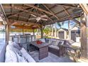 This covered outdoor area is perfect for entertaining, featuring a kitchen and large seating area at 352 Radisson Pl, Oviedo, FL 32765