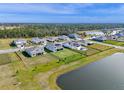 Neighborhood aerial shot of the backyard, showcasing a fence and lake views at 4228 Sunset Preserve Blvd, Orlando, FL 32820