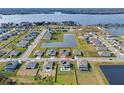 Aerial view of a neighborhood featuring a home with a neatly maintained yard and nearby lake at 4228 Sunset Preserve Blvd, Orlando, FL 32820