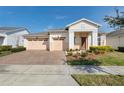 Charming home boasting a three-car garage, well-manicured landscaping, and a welcoming front entrance at 4909 Drawdy Ct, St Cloud, FL 34772