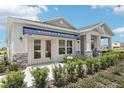 Model home with a Stanley Martin sign, stone accents, and lush landscaping at 5929 Cliffbow Loop, Leesburg, FL 34748