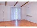 Bright living room with vaulted ceiling, wood beams and wood laminate flooring at 630 Carpenter Rd, Orlando, FL 32833