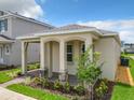 Cozy single-story home featuring a covered front porch with stone pillars and manicured front yard at 652 Kimber Ln, Debary, FL 32713