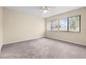 Bright bedroom with neutral carpet, a ceiling fan, and two windows providing natural light at 95 Carolwood Blvd, Fern Park, FL 32730