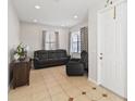 Inviting living room features neutral paint, tile floors, and large windows that allow natural light at 3446 Allegra Cir, St Cloud, FL 34772