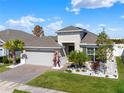 Well-maintained single-story home featuring a two-car garage, landscaped front yard with decorative rock at 1204 Pando Loop, Orlando, FL 32824