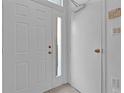 Bright entryway with a white front door with sidelight, white interior door, and neutral tile flooring at 1710 San Jacinto Cir # 1710, Sanford, FL 32771