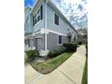 Side view of the three-story condo showing the walkway and landscaping at 1710 San Jacinto Cir # 1710, Sanford, FL 32771