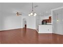 Open-concept living room with hardwood floors, neutral walls, chandelier lighting, and a ceiling fan at 1710 San Jacinto Cir # 1710, Sanford, FL 32771