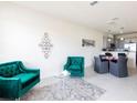 Well-lit living space showcasing contemporary teal colored furniture and an elegant area rug at 1766 Coriander Dr, Kissimmee, FL 34759