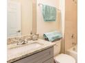 Stylish bathroom with granite countertops, modern fixtures, and a pristine bathtub/shower combo at 1772 Coriander Dr, Kissimmee, FL 34759