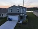 Two-story home with a two-car garage and landscaped front yard at 1926 Golden Beak Dr, Eagle Lake, FL 33839