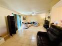 Spacious living room featuring neutral tile flooring and comfortable sectional seating at 282 Scottsdale Sq # 282, Winter Park, FL 32792