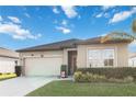 Attractive single-story home showcasing well-maintained landscaping, neutral tones, and an attached two-car garage at 2857 Neverland Dr, New Smyrna Beach, FL 32168