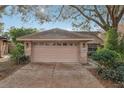 Charming home with an attached garage, complemented by lush greenery and landscaping at 302 Bridie Ct, Winter Springs, FL 32708