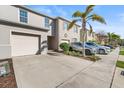 View of a well-kept driveway with a two-car garage and a nicely landscaped yard at 360 Arbor Lakes Dr, Davenport, FL 33896