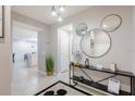 Inviting entryway with console table leading to living area with bright tile floor at 3926 Lana Ave, Davenport, FL 33897