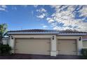 Attached two-car garage with a brick-paved driveway beneath a bright blue sky at 4119 Bella Isle Cir, Kissimmee, FL 34746