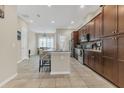 Spacious kitchen with dark wood cabinets, granite countertops, and stainless steel appliances at 486 Windmill Palm Cir, Altamonte Springs, FL 32701