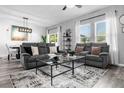 Bright living room featuring comfortable gray seating, stylish decor, and ample natural light at 4860 Osprey Way, Winter Haven, FL 33881