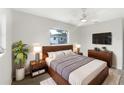 Cozy bedroom featuring a ceiling fan, wood furniture, and plush bedding at 5404 Milan Dr, Orlando, FL 32810