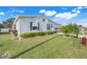 Well-maintained home featuring lush green lawn and mature landscaping at 6302 Bayberry Ne Blvd, Winter Haven, FL 33881