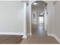 Bright hallway featuring tile flooring, arched doorways, and decorative columns at 6825 Dolce St, Orlando, FL 32819