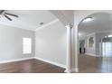 Spacious living room with hardwood floors and decorative columns at 6825 Dolce St, Orlando, FL 32819