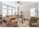 Bright living room with large windows, hardwood floors, neutral color palette, and stylish decor at 6825 Dolce St, Orlando, FL 32819
