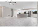 Bright and airy living room with marble-look tile floors and modern kitchen with stainless steel appliances at 855 S Hancock Dr, Deltona, FL 32725