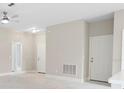 Neutral-toned living area featuring recessed lighting, white doors, and marble-look floors at 855 S Hancock Dr, Deltona, FL 32725