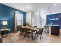 Dining area featuring stylish decor, a blue accent wall, and an open floor plan at 8920 Rhodes St, Kissimmee, FL 34747