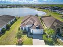 Beautiful aerial shot showcasing a home's lush landscaping and tranquil lake view at 113 Azure Mist Way, Daytona Beach, FL 32124