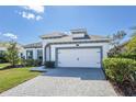 Attractive home exterior showcasing a spacious driveway leading to a two-car garage at 113 Azure Mist Way, Daytona Beach, FL 32124