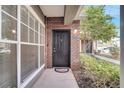 Charming front door with brick accents and manicured landscaping creates a welcoming entrance at 11901 Sandy Knoll Ct # 814, Orlando, FL 32825