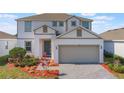 Beautiful two-story home with manicured landscaping and a two-car garage at 1260 Tupelo Trl, Haines City, FL 33844