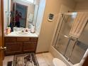 Full bathroom features a shower-tub combo, single vanity, and large mirror at 1473 Disston Ave, Clermont, FL 34711